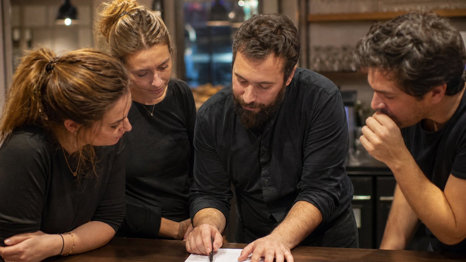 Membre d'une équipe de restaurant examinant le décompte détaillé de sa part de tronc
